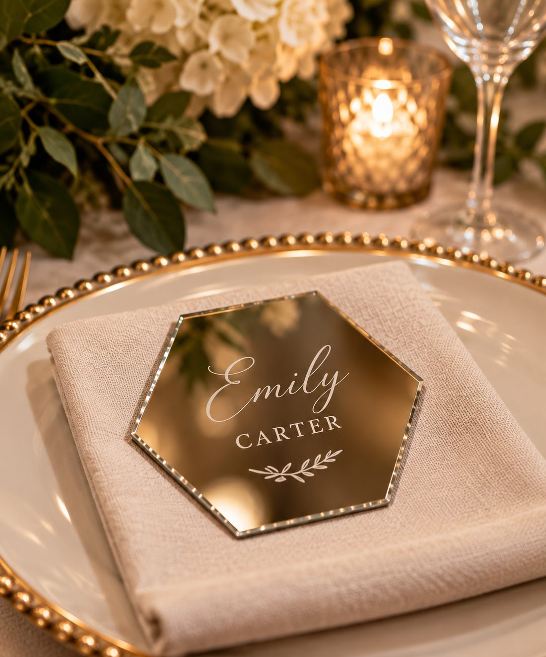 Personalized engraved hexagon mirror keepsake with a guest name, resting on a folded napkin